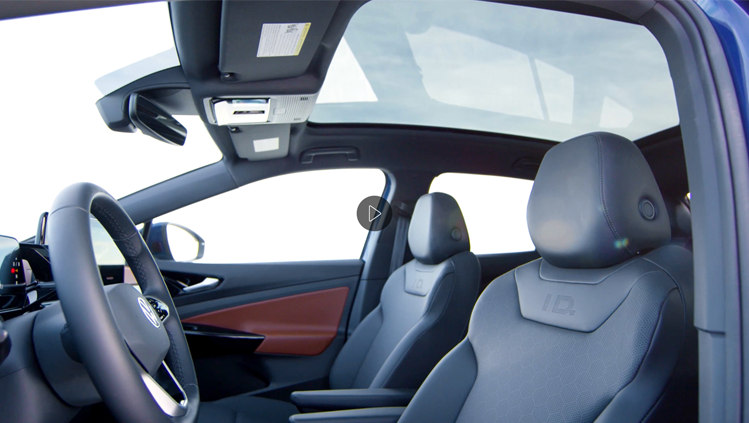 An interior shot of an ID.4 showcasing the steering wheel, front seats and passenger side door panel.